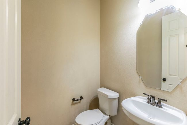 Half bathroom across the hall from office on first floor, perfect for guest access | Image 37
