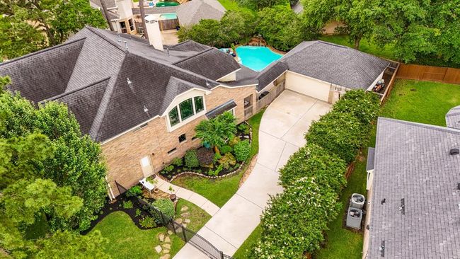 A side view of the home, which offers privacy and a wonderful place for children to play and ride bikes behind the safety of your own driveway gate. | Image 4