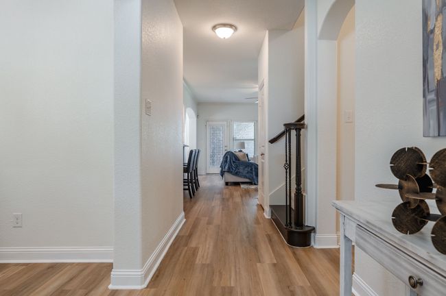 Hall with light wood-style flooring and baseboards | Image 5
