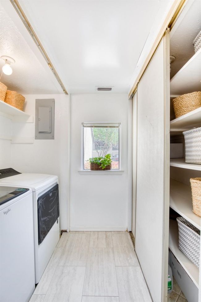Washroom featuring electric panel and washing machine and clothes dryer | Image 16
