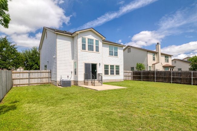 Back of house with a lawn, central AC unit, a patio, and a fenced backyard | Image 32
