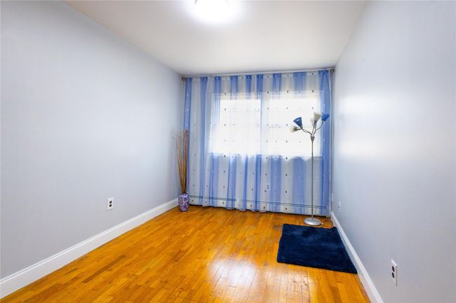 Spare room featuring hardwood / wood-style floors and baseboards | Image 21