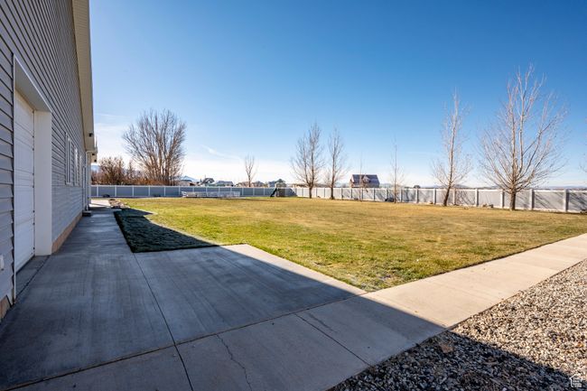 View of yard with a fenced backyard and a patio | Image 61