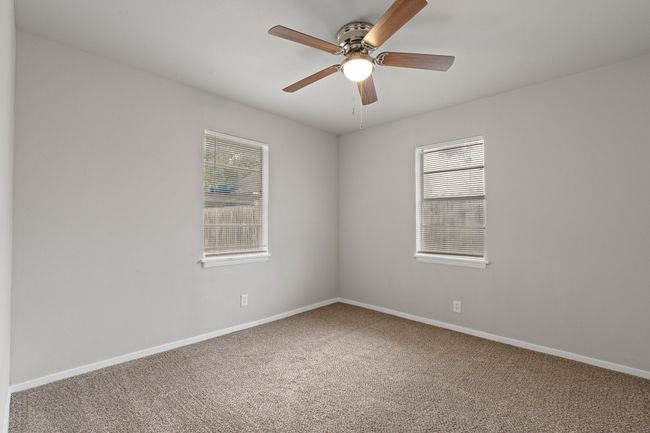 Empty room featuring healthy amount of natural light, carpet floors, and a ceiling fan | Image 15