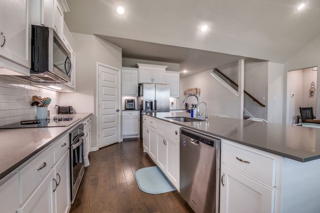 Kitchen featuring stainless steel appliances including an electric cooktop. Notice the corner pantry | Image 8
