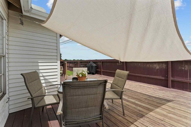 Cozy covered nook on the deck — your go-to spot for shade, sips, and relaxing vibes anytime. | Image 24