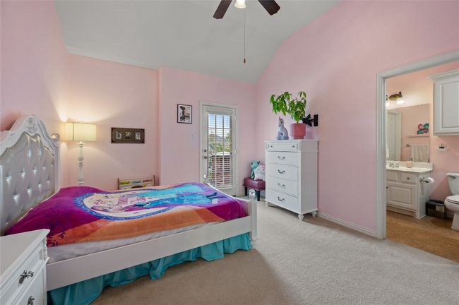 Bedroom with light carpet, vaulted ceiling, ensuite bathroom, ceiling fan, and access to exterior | Image 34