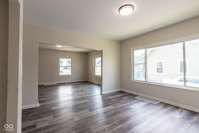 spare room featuring baseboards, dark wood-style flooring, and visible vents | Image 10