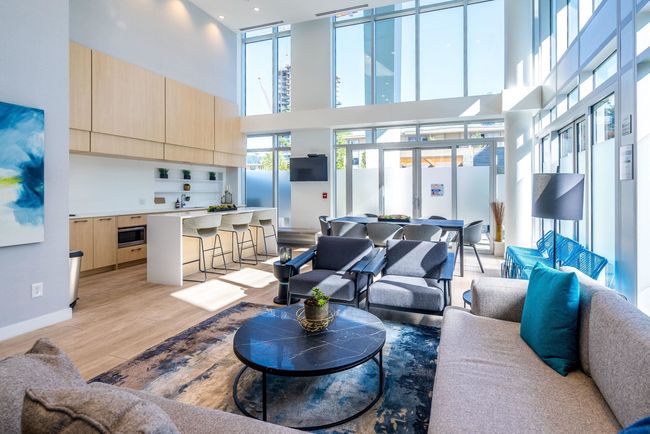 Living room with light wood-style flooring, a high ceiling, and baseboards | Image 20