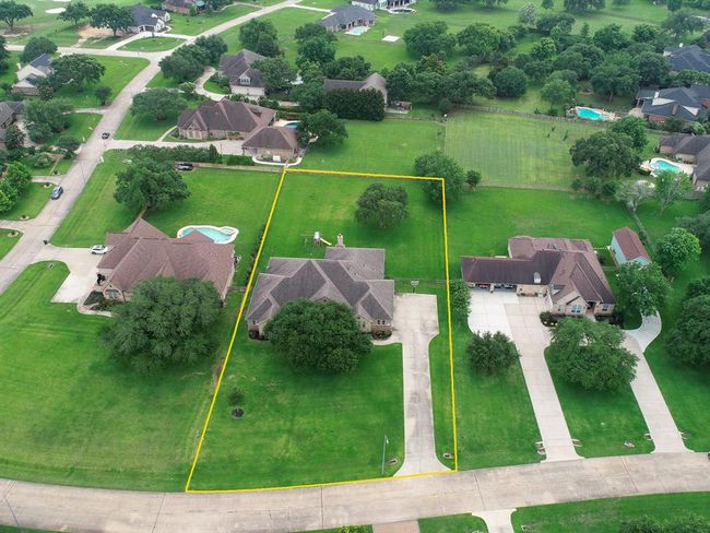 This bird’s eye view showcases the homes spacious one acre lot on this quiet, country street. The home’s central location makes for both a large Front and Back Yard. Space like this is hard to find anywhere else! | Image 45