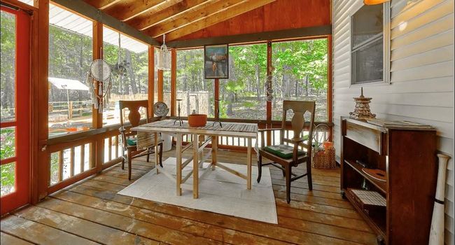 Sunroom featuring lofted ceiling with beams, wooden ceiling, and a healthy amount of sunlight | Image 17