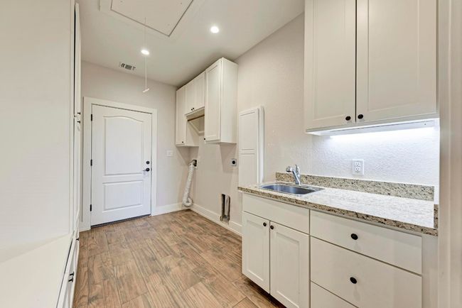 Spacious Laundry with Ample Storage and Built-in Ironing Board | Image 33