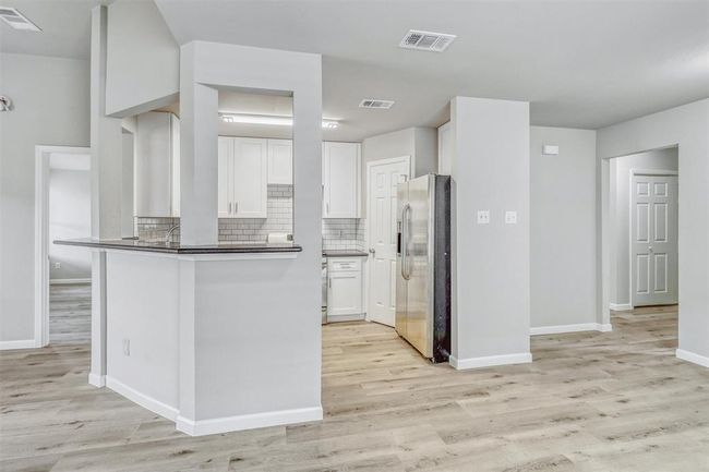 The spacious breakfast bar provides ample room for barstools, creating a perfect spot for casual dining or quick meals. | Image 15