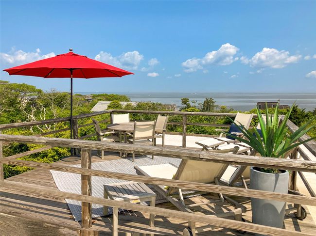 Wooden deck featuring outdoor dining area and a water view | Image 8