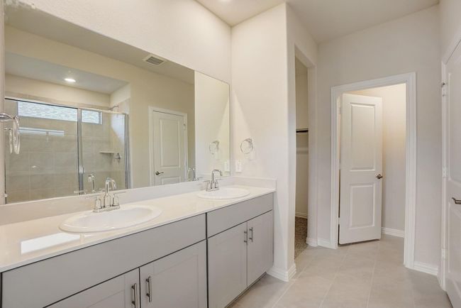Bathroom with a stall shower, light tile patterned flooring, and recessed lighting | Image 9