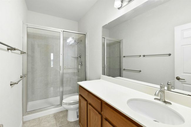 This full bathroom on the second level features a shower and tub combo. | Image 16