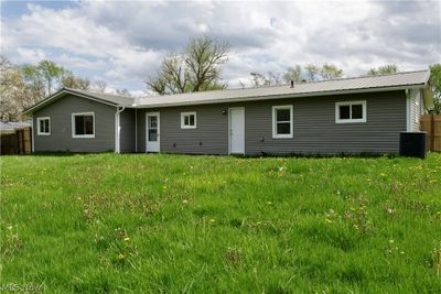 Rear view of property featuring a yard and central AC unit | Image 3