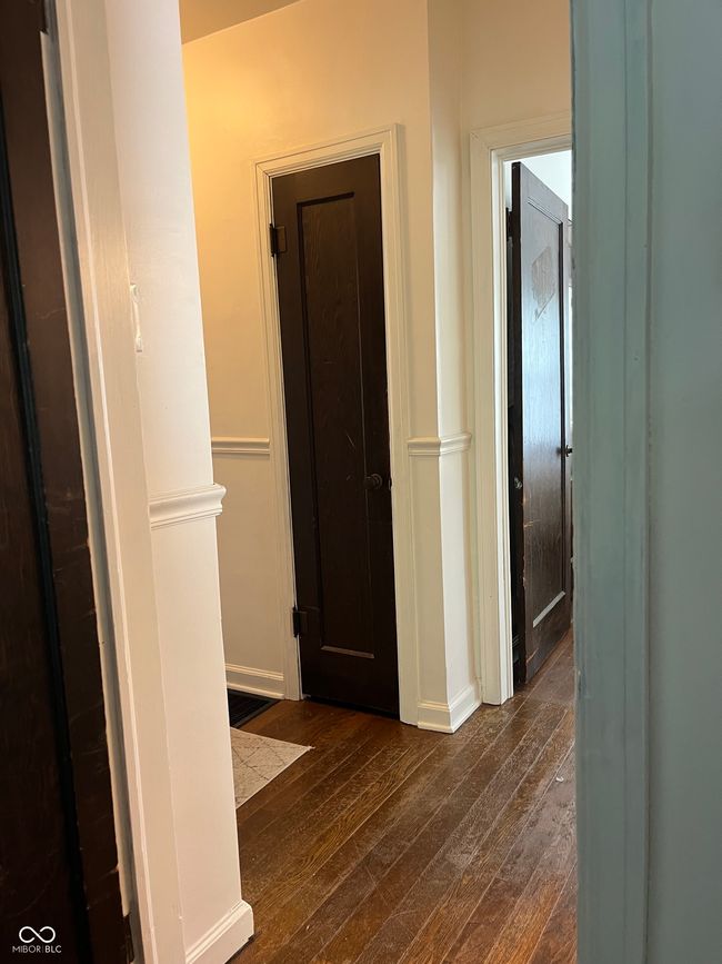 hall with dark wood-style flooring and baseboards | Image 12