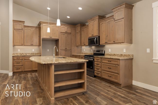 Kitchen featuring stainless steel appliances, open shelves, light stone counters, dark wood-type flooring, and recessed lighting | Image 15