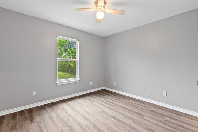 Empty room with wood finished floors and a ceiling fan | Image 17