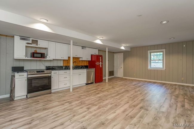 Brick floors are under the luxury vinyl planks. The walls are painted solid pine. | Image 64