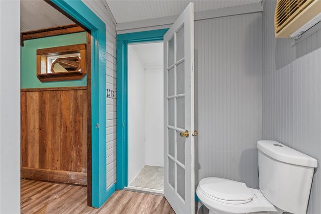 Bathroom with wood finished floors and wood walls | Image 32