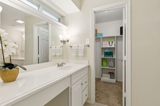 Primary Ensuite Bathroom with double vanities, dual sinks, and frameless walk-in shower | Image 15