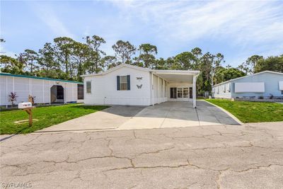 Manufactured / mobile home with a carport and a front yard | Image 2