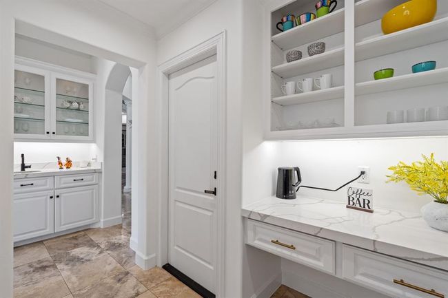 Elegant butler’s pantry, complete with a sitting area, quartz countertops, built-in shelving, and ample storage—adding both style and function to the heart of the home. | Image 14
