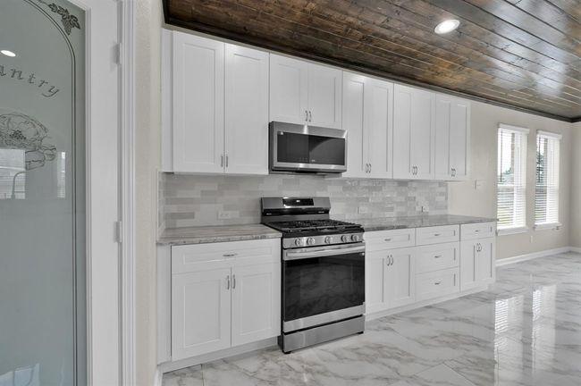 Kitchen and breakfast area on the right. | Image 16