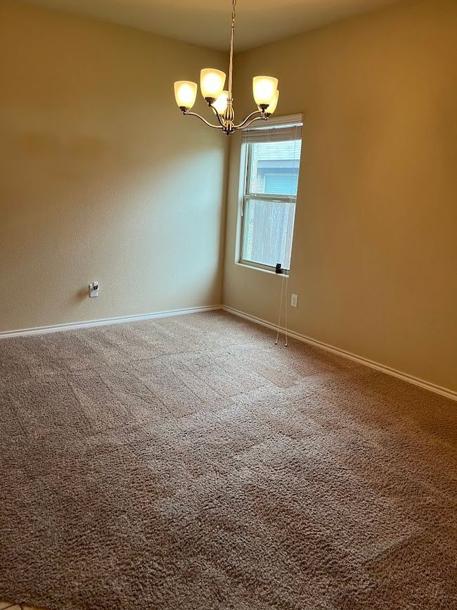 Spare room featuring a chandelier, baseboards, and carpet | Image 23