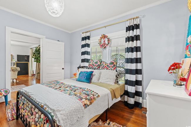 Bedroom featuring wood finished floors and ornamental molding | Image 22