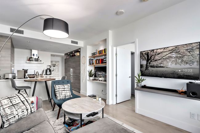 Living room with wood finished floors and visible vents | Image 6
