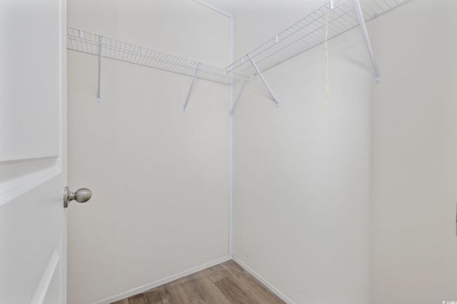 Walk in closet featuring light wood-style flooring | Image 26