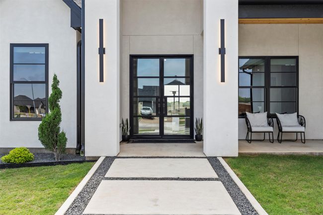 Entrance to property with french doors, stucco siding, and a yard | Image 4