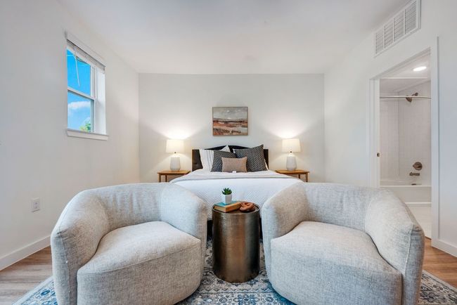 Bedroom featuring wood finished floors, connected bathroom, and baseboards | Image 23