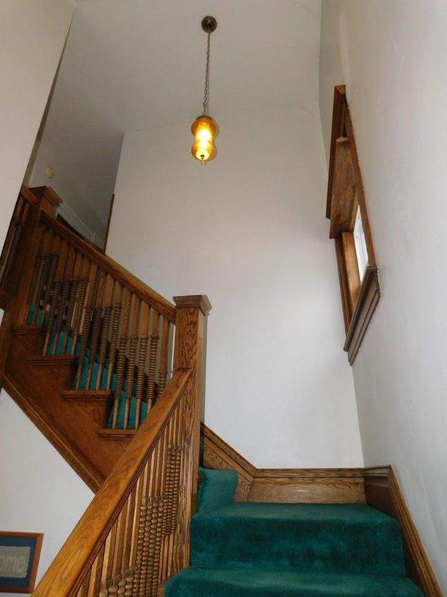 Original light fixtures in foyer and staircase. | Image 23