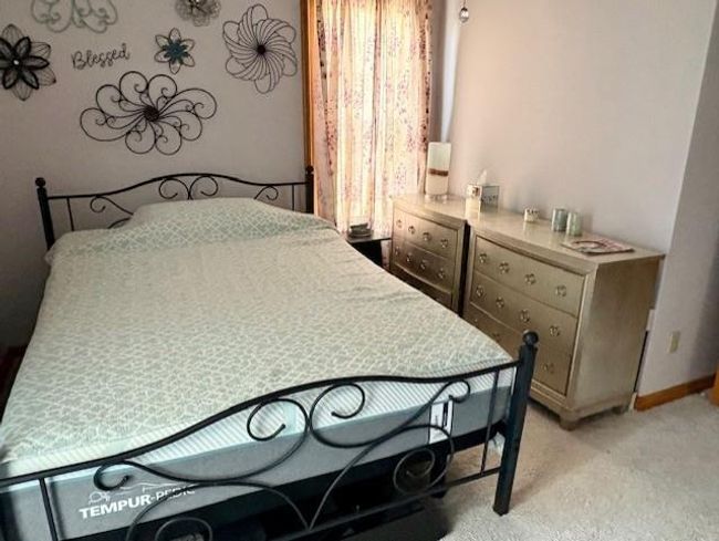 Bedroom featuring baseboards, multiple windows, and light colored carpet | Image 26