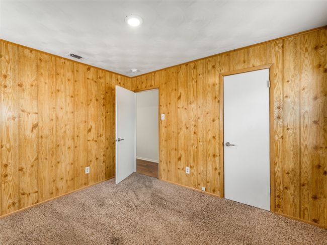 Unfurnished room with carpet and wood walls | Image 25