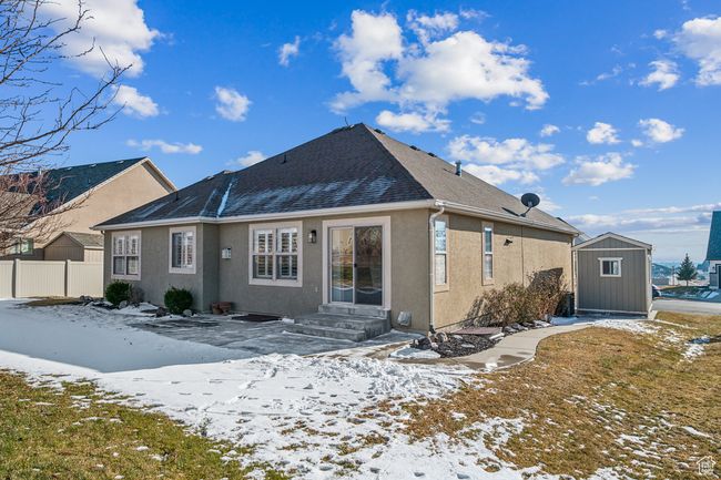 Snow covered house featuring a storage unit | Image 41