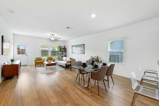 Dining space featuring light wood-style flooring and a ceiling fan | Image 10