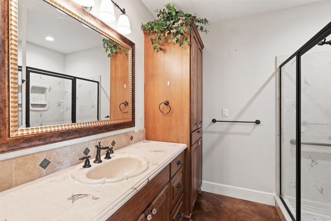Bathroom with a stall shower, vanity, and baseboards | Image 20