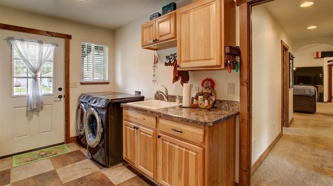 Washroom with independent washer and dryer, cabinet space, baseboards, arched walkways, and recessed lighting | Image 30