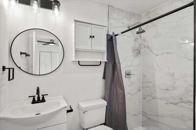 Bathroom with vanity and a marble finish shower | Image 4