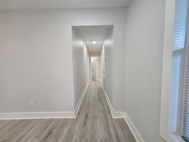 Hallway with wood finished floors and attic access | Image 11