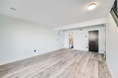 Spare room featuring light hardwood / wood-style flooring and a textured ceiling | Image 3