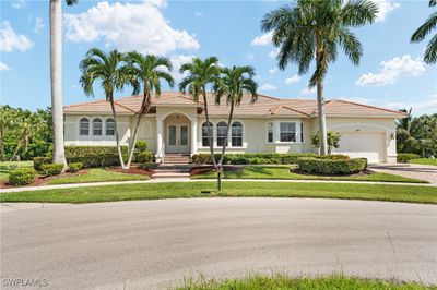 Mediterranean / spanish-style house with a front yard and a garage | Image 1