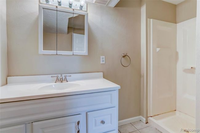 Full bath in the lower level with ceramic flooring and large vanity. | Image 21