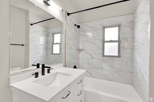 Full bathroom with vanity, tub / shower combination, plenty of natural light, and toilet | Image 15