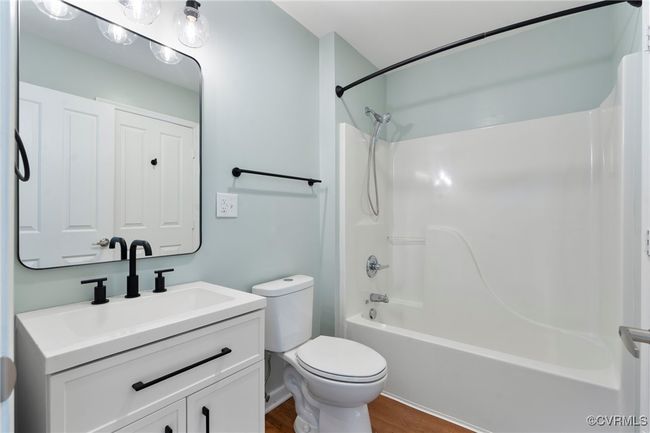 Bathroom featuring vanity, toilet, wood finished floors, and shower combination | Image 14